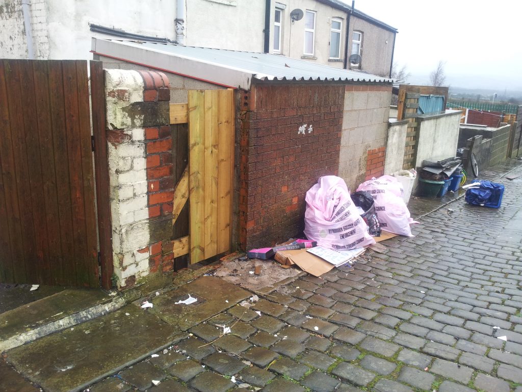 Fly-tipping in an alley: the British towns where houses are too cheap