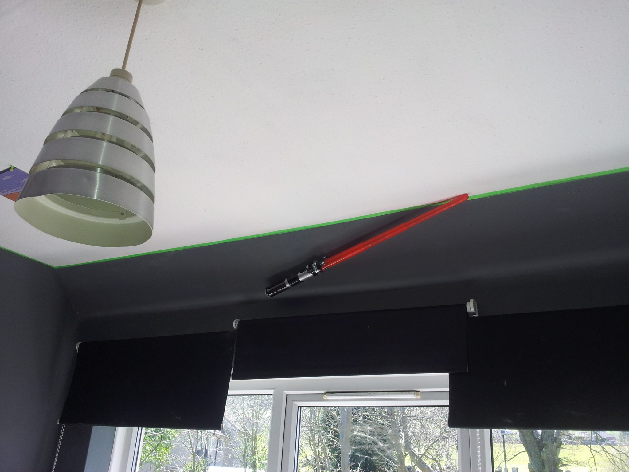 Star Wars bedroom makeover - three overlapping black roller blinds at window and metal lampshade