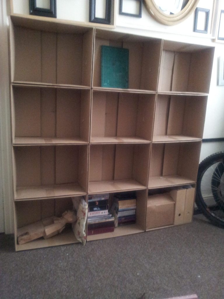 Cardboard boxes used as art studio shelving