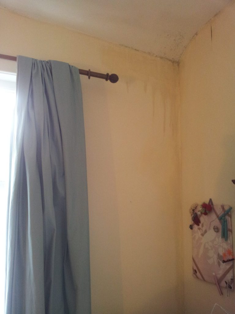 Water running down the walls from the ceiling in a poorly maintained rented house.