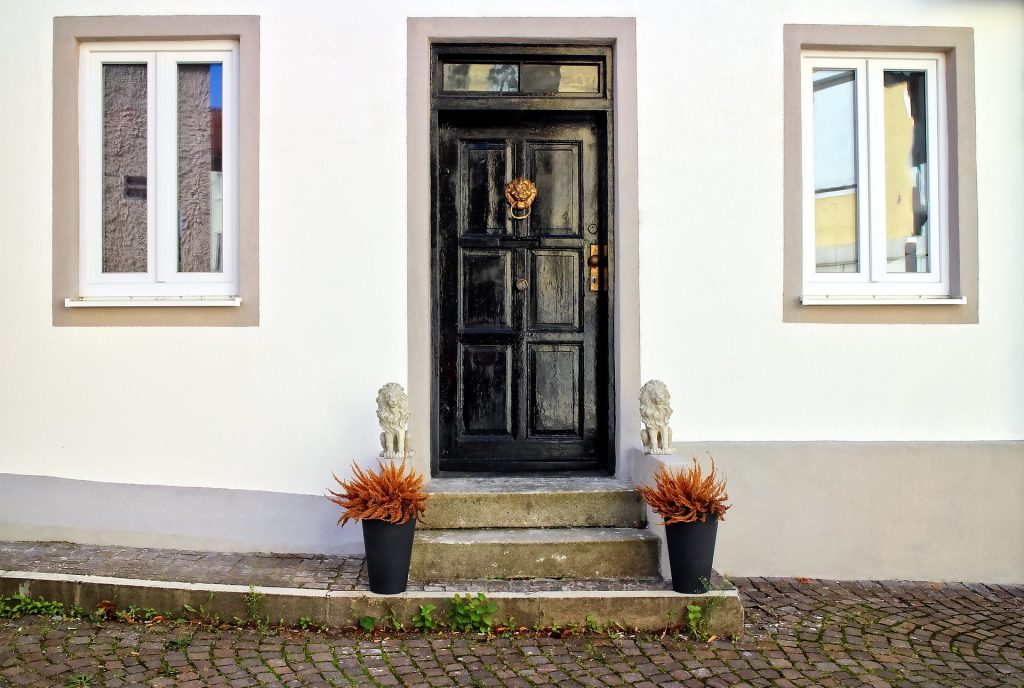 Black front door with brass knocker and knob