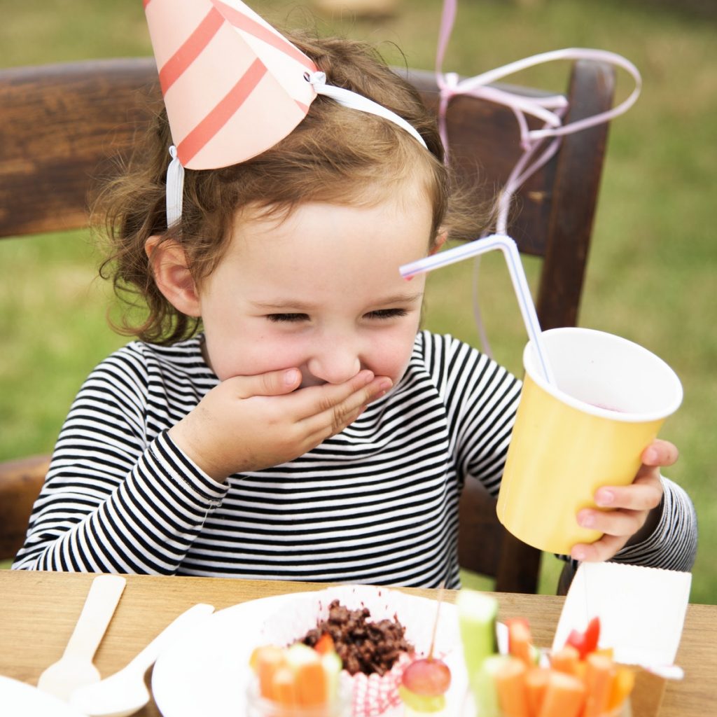 Child enjoying garden party.